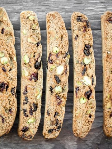 Festive cranberry pistachio biscotti are crunchy, delicious, and perfect for dunking. This Italian cookie is easy to make with warm holiday flavours. | aheadofthyme.com
