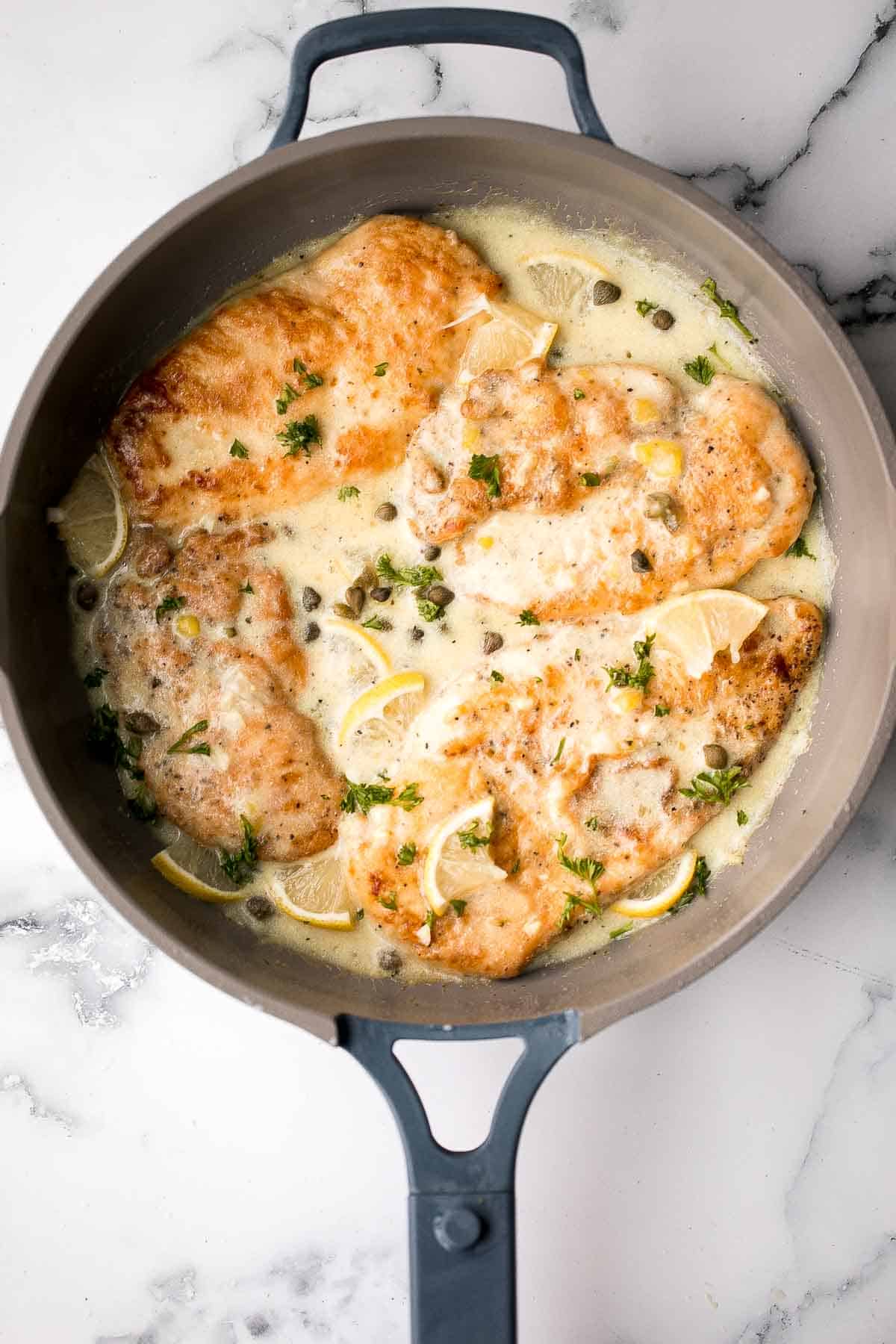 Quick and easy, creamy lemon chicken piccata is a simple and delicious 30-minute meal made with tender chicken breast in a light lemon sauce with capers. | aheadofthyme.com
