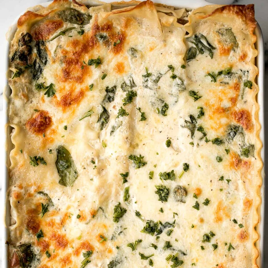 Creamy white chicken and spinach lasagna with tender shredded chicken is the most comforting creamiest cheesiest white lasagna. Easy to make ahead & freeze. | aheadofthyme.com