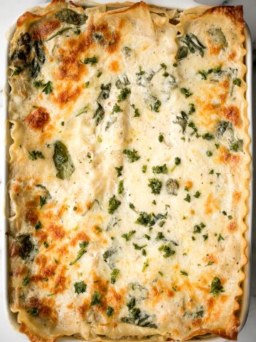Creamy white chicken and spinach lasagna with tender shredded chicken is the most comforting creamiest cheesiest white lasagna. Easy to make ahead & freeze. | aheadofthyme.com