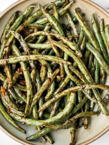 Easy Air Fryer Green Beans are crispy, garlicky, and ready in 10 minutes - a quick, flavorful side for any meal. | aheadofthyme.com