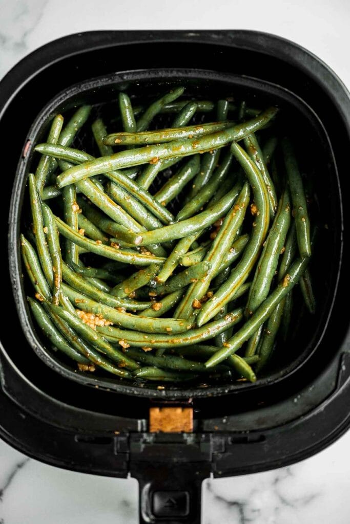 Easy Air Fryer Green Beans are crispy, garlicky, and ready in 10 minutes — a quick, flavorful side for any meal. | aheadofthyme.com