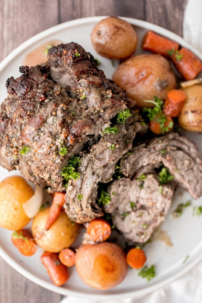 Easy roast lamb with vegetables is tender, juicy, and succulent and packed incredible flavour. This fancy holiday dinner is easy to prep in just 15 minutes. | aheadofthyme.com