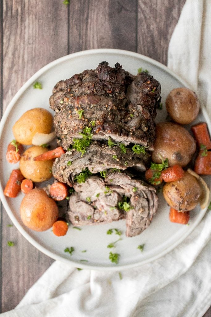 Easy roast lamb with vegetables is tender, juicy, and succulent and packed incredible flavour. This fancy holiday dinner is easy to prep in just 15 minutes. | aheadofthyme.com