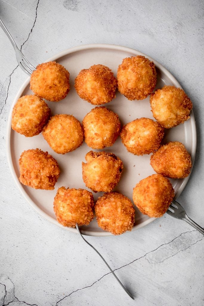 Fried mac and cheese balls are crispy on the outside, creamy and cheesy on the inside, and have the perfect crunch. Best way to use leftover mac and cheese. | aheadofthyme.com