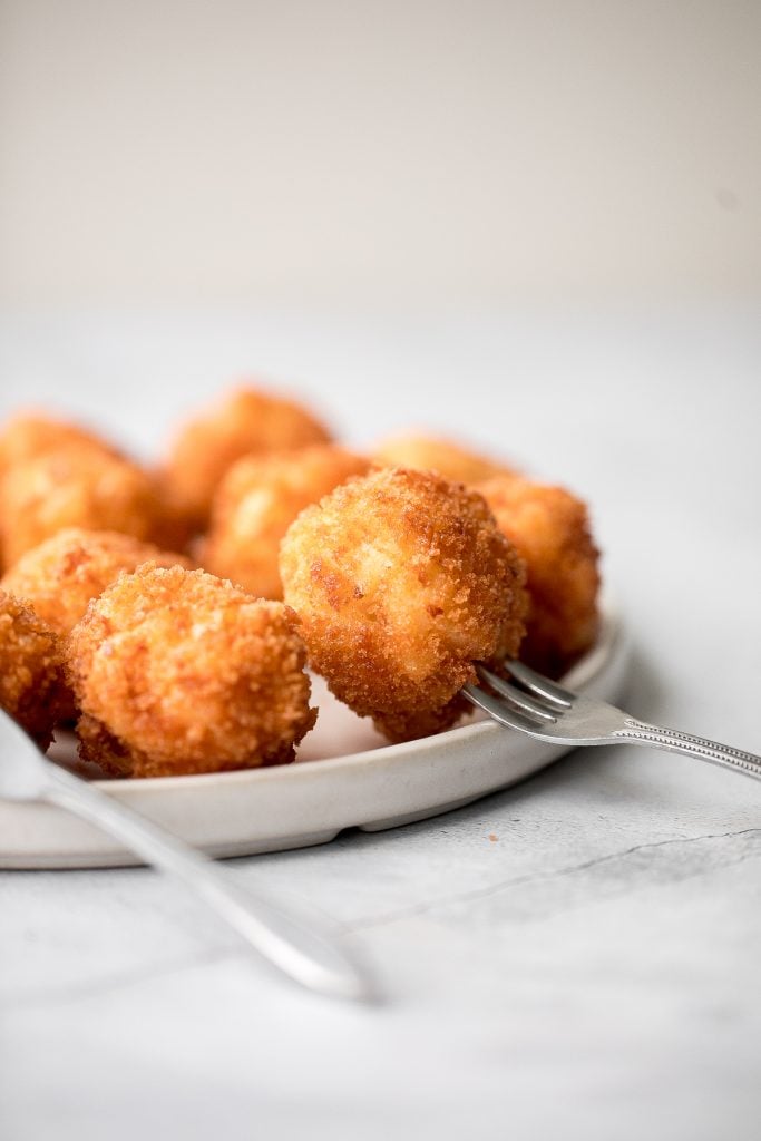 Fried mac and cheese balls are crispy on the outside, creamy and cheesy on the inside, and have the perfect crunch. Best way to use leftover mac and cheese. | aheadofthyme.com