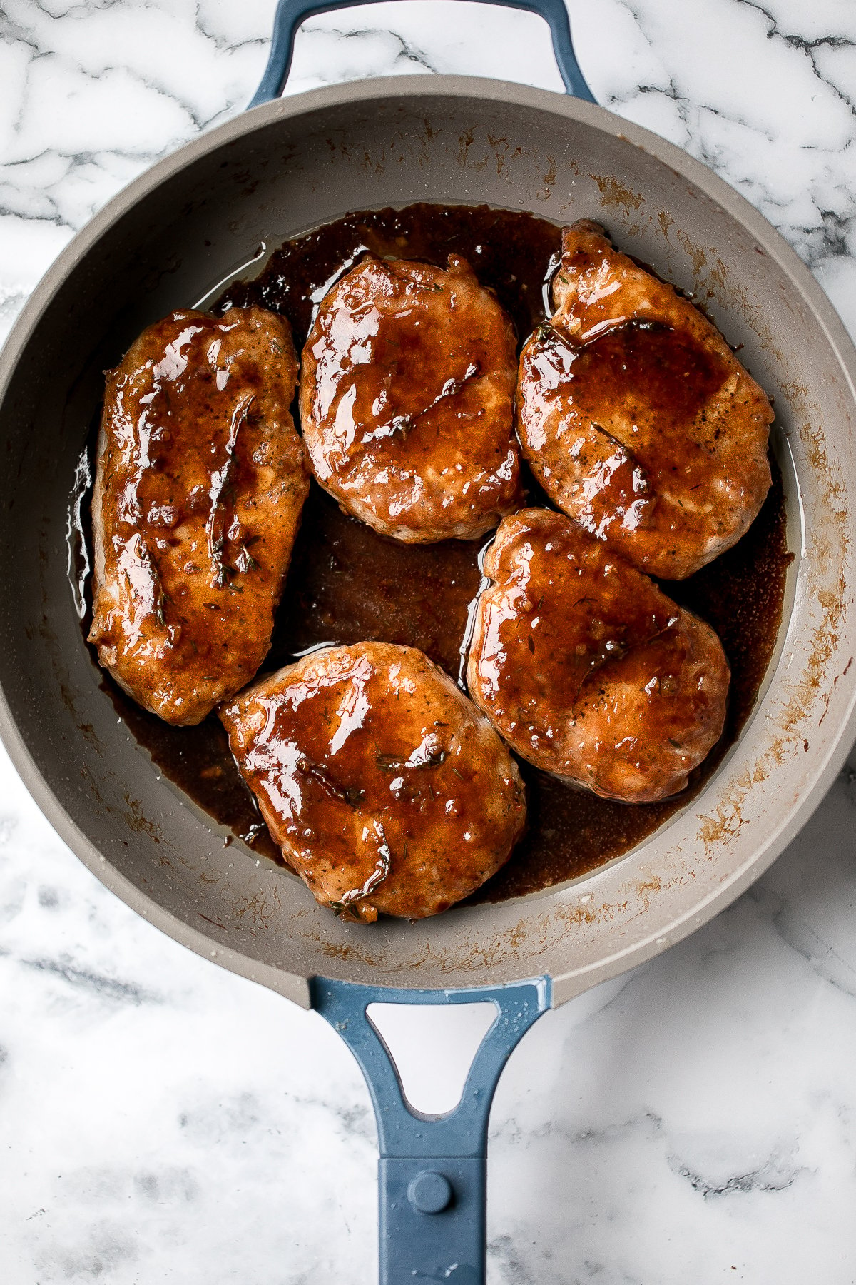 Quick and easy, glazed honey balsamic pork chops are tender and juicy, seared in thyme and coated with a honey balsamic sauce. Make it in under 30 minutes. | aheadofthyme.com