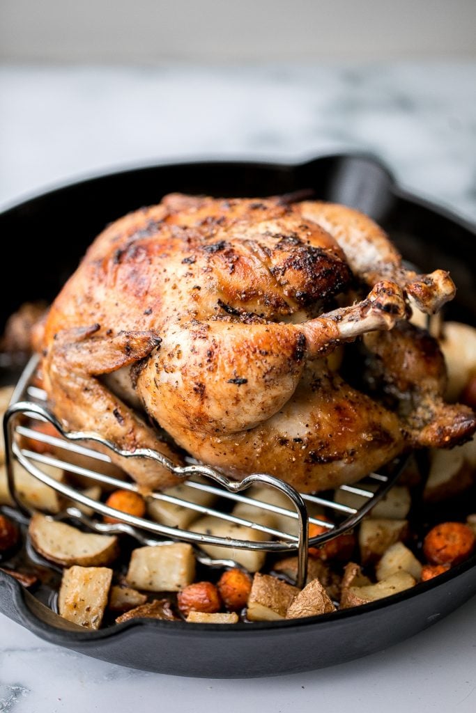 Easy Greek lemon garlic whole roast chicken is tender, juicy and succulent with the crispiest skin. Prep this flavourful one pan meal in just 15 minutes. | aheadofthyme.com