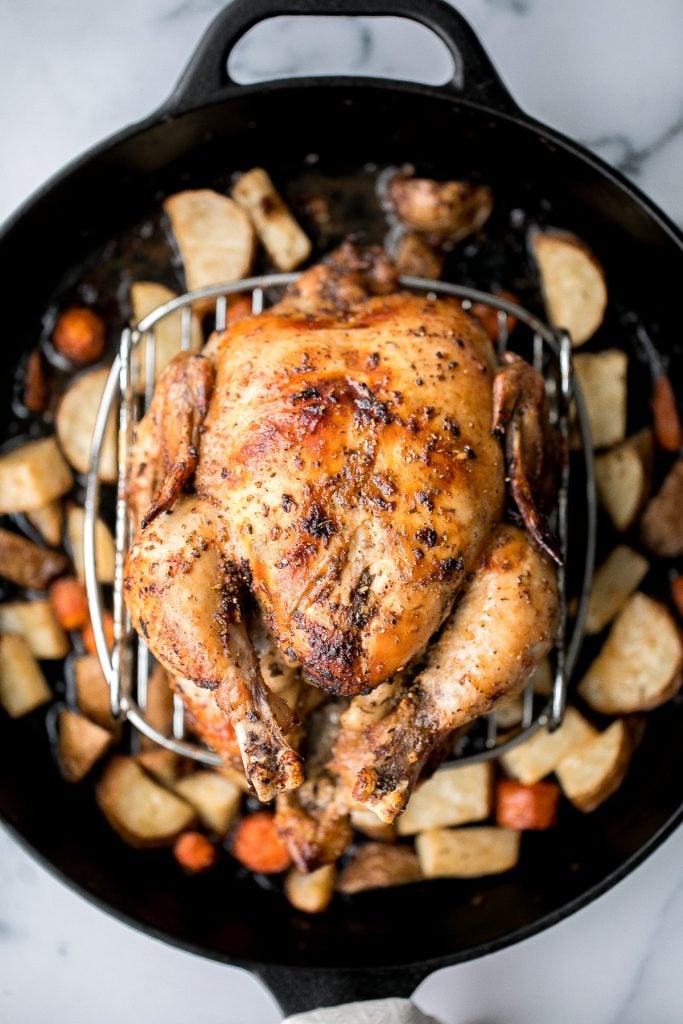 Easy Greek lemon garlic whole roast chicken is tender, juicy and succulent with the crispiest skin. Prep this flavourful one pan meal in just 15 minutes. | aheadofthyme.com