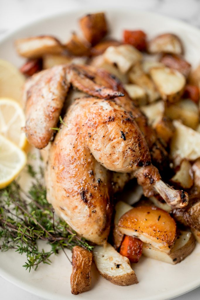 Easy Greek lemon garlic whole roast chicken is tender, juicy and succulent with the crispiest skin. Prep this flavourful one pan meal in just 15 minutes. | aheadofthyme.com