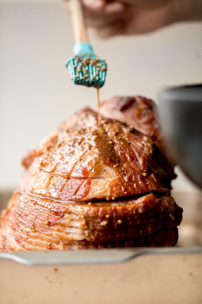 Easy holiday glazed baked ham is juicy, succulent and flavourful, coated in a brown sugar honey glaze with and baked until caramelized and golden brown. | aheadofthyme.com