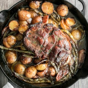 Easy one pan honey glazed roast pork is moist, tender, and juicy, coated with an irresistible honey glaze and packed with potatoes, green beans and apples. | aheadofthyme.com