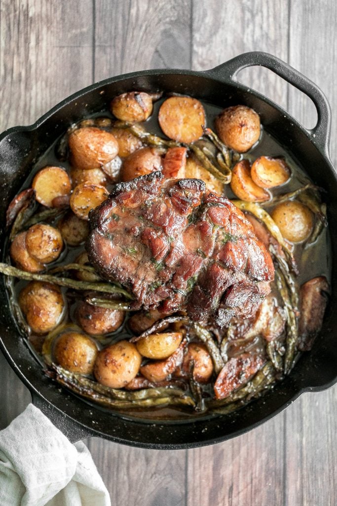 Easy one pan honey glazed roast pork is moist, tender, and juicy, coated with an irresistible honey glaze and packed with potatoes, green beans and apples. | aheadofthyme.com