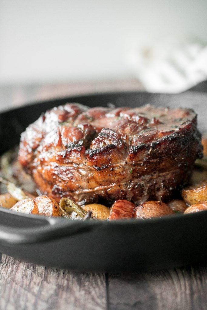 Easy one pan honey glazed roast pork is moist, tender, and juicy, coated with an irresistible honey glaze and packed with potatoes, green beans and apples. | aheadofthyme.com