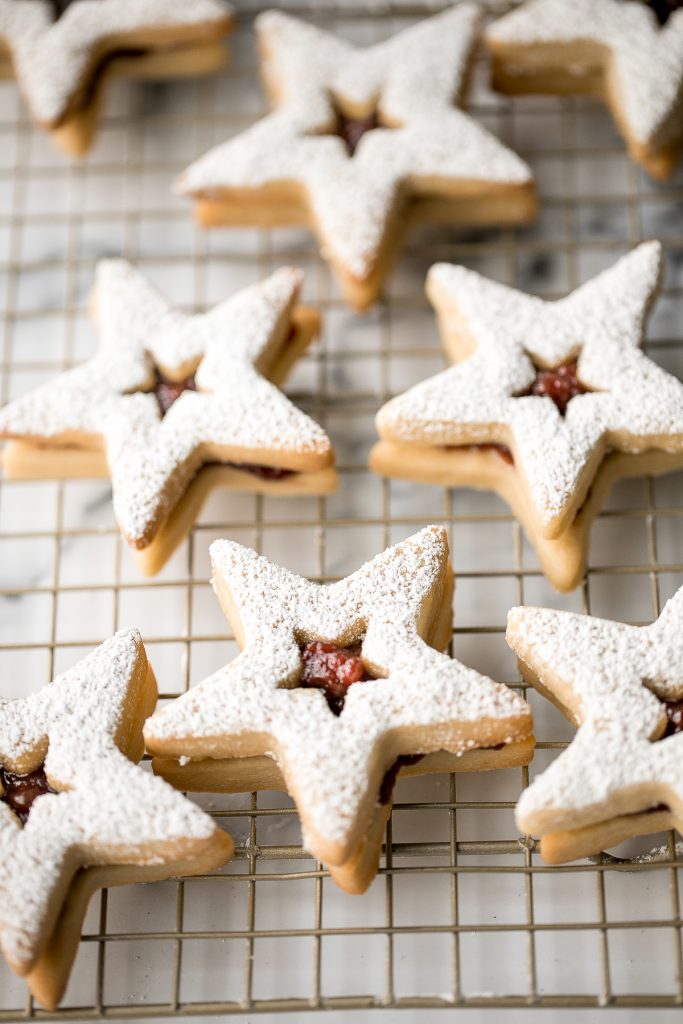 Sweet buttery linzer cookies are a classic Christmas cookie with flaky shortbread and fruit jam. The perfect festive holiday treat that melts in your mouth. | aheadofthyme.com