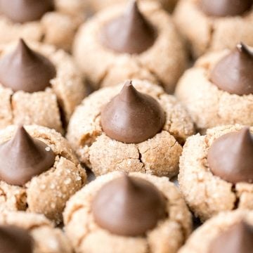 Soft chewy peanut butter blossoms topped with a chocolate kiss are a classic Christmas cookie that is easy to make during the holidays or any time of year. | aheadofthyme.com