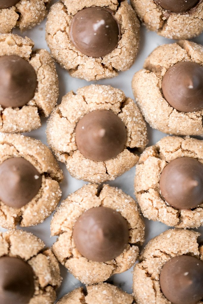 Soft chewy peanut butter blossoms topped with a chocolate kiss are a classic Christmas cookie that is easy to make during the holidays or any time of year. | aheadofthyme.com