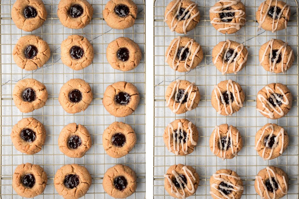 Melt-in-your-mouth peanut butter thumbprint cookies with raspberry jam and a drizzle of maple cinnamon glaze are the best holiday cookies and easy to make. | aheadofthyme.com