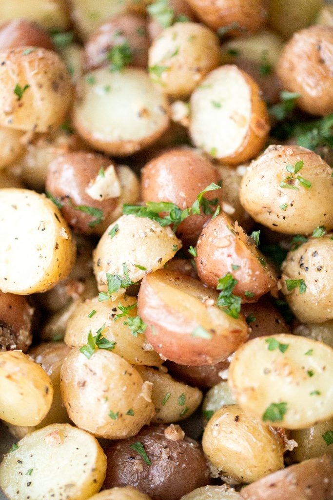 Quick and easy roasted garlic Parmesan baby potatoes are crispy on the edges and tender inside. They are delicious, flavourful and bakes in just 30 minutes. | aheadofthyme.com