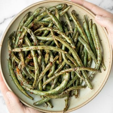 Quick easy roasted garlic green beans are tangy, sour, savoury, and sweet, with a tender and crunchy texture. Make them in the oven or air fryer in minutes. | aheadofthyme.com