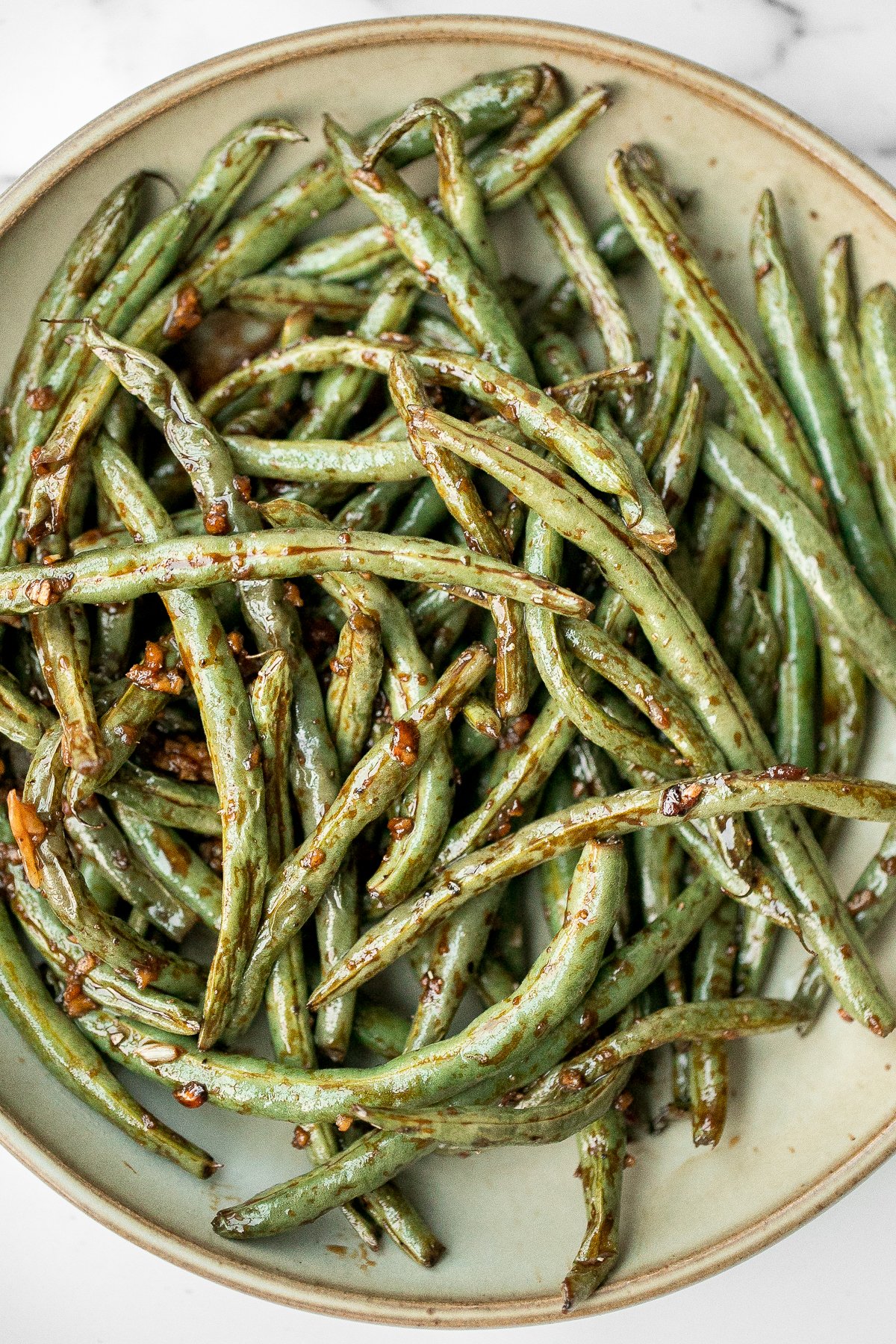Quick easy roasted garlic green beans are tangy, sour, savoury, and sweet, with a tender and crunchy texture. Make them in the oven or air fryer in minutes. | aheadofthyme.com