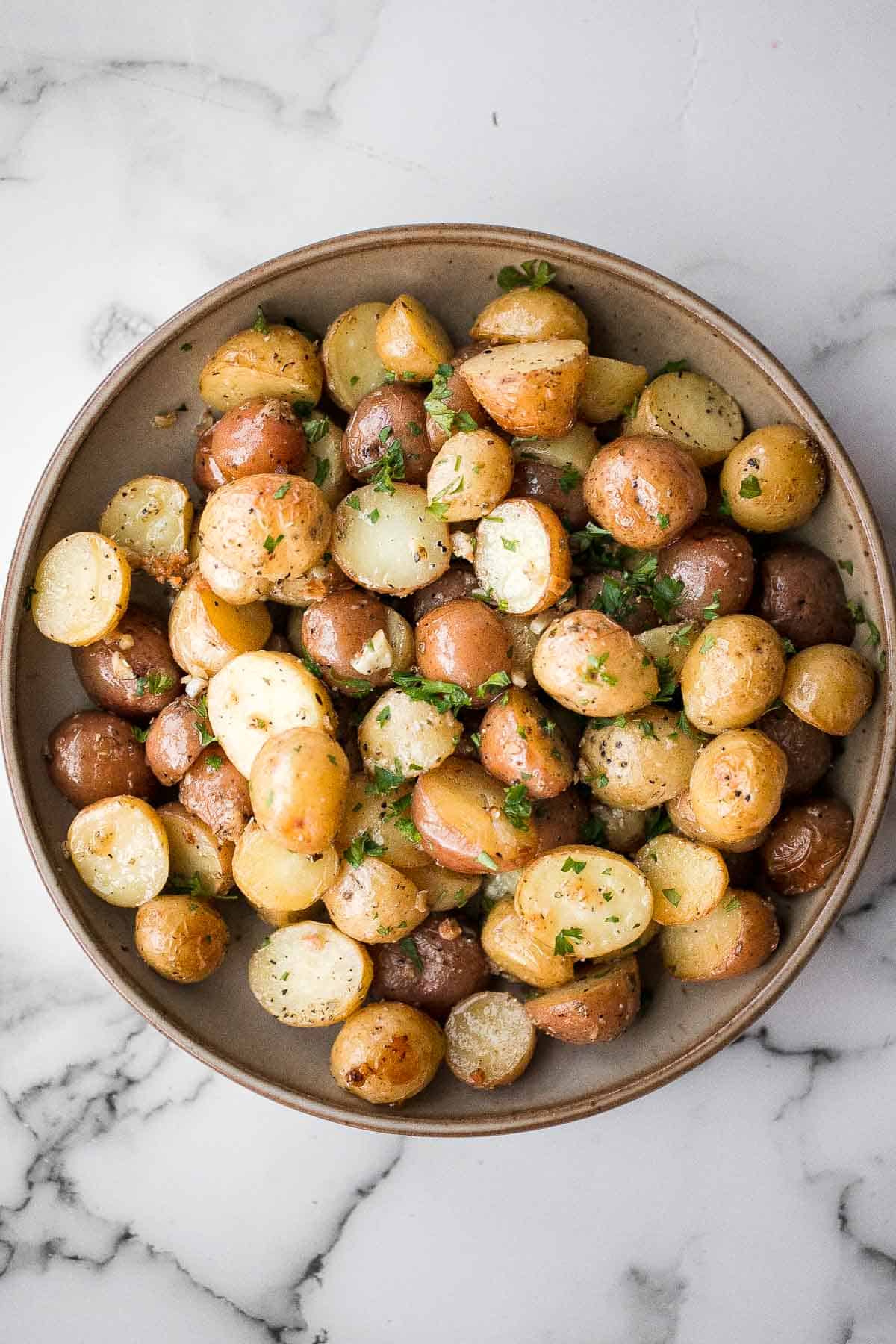 Crispy roasted garlic Parmesan baby potatoes are golden, cheesy, and flavorful. An easy 40-minute side dish perfect for dinner or holidays. | aheadofthyme.com