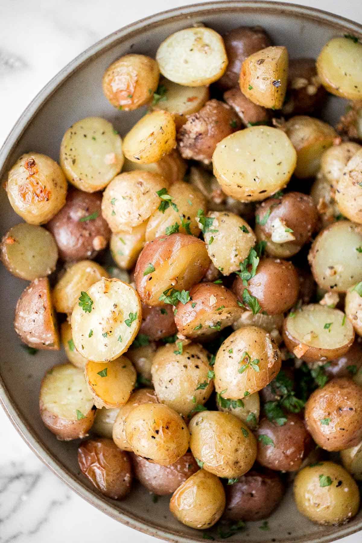 Crispy roasted garlic Parmesan baby potatoes are golden, cheesy, and flavorful. An easy 40-minute side dish perfect for dinner or holidays. | aheadofthyme.com