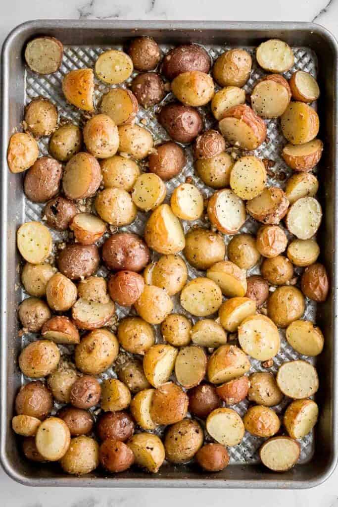Crispy roasted garlic Parmesan baby potatoes are golden, cheesy, and flavorful. An easy 40-minute side dish perfect for dinner or holidays. | aheadofthyme.com
