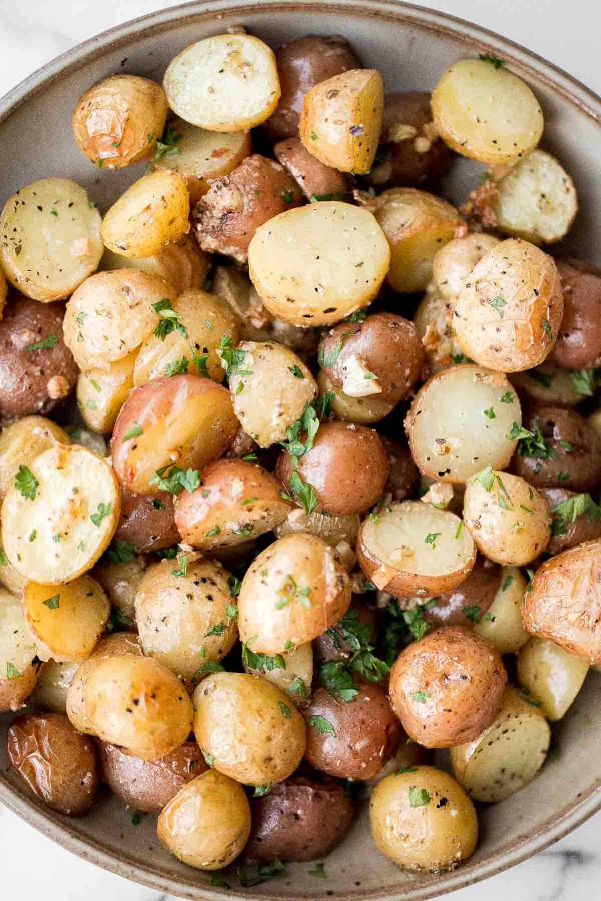 Crispy roasted garlic Parmesan baby potatoes are golden, cheesy, and flavorful. An easy 40-minute side dish perfect for dinner or holidays. | aheadofthyme.com