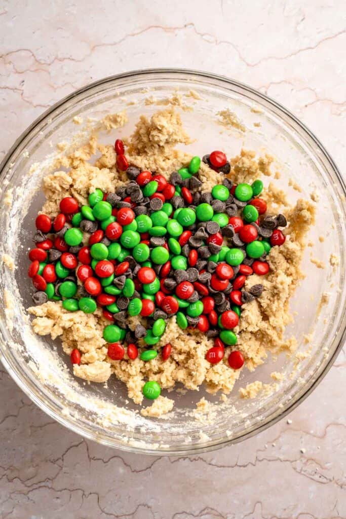 Festive red and green M&M Christmas Cookies that are soft, chewy, and crisp at the edges. Quick and easy, ready in about 20 minutes. | aheadofthyme.com
