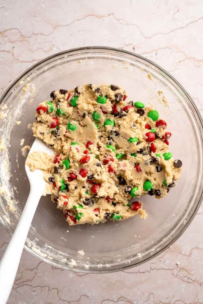 Festive red and green M&M Christmas Cookies that are soft, chewy, and crisp at the edges. Quick and easy, ready in about 20 minutes. | aheadofthyme.com