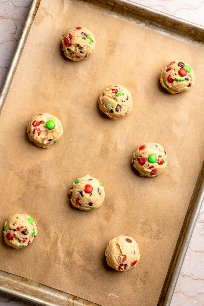 Festive red and green M&M Christmas Cookies that are soft, chewy, and crisp at the edges. Quick and easy, ready in about 20 minutes. | aheadofthyme.com