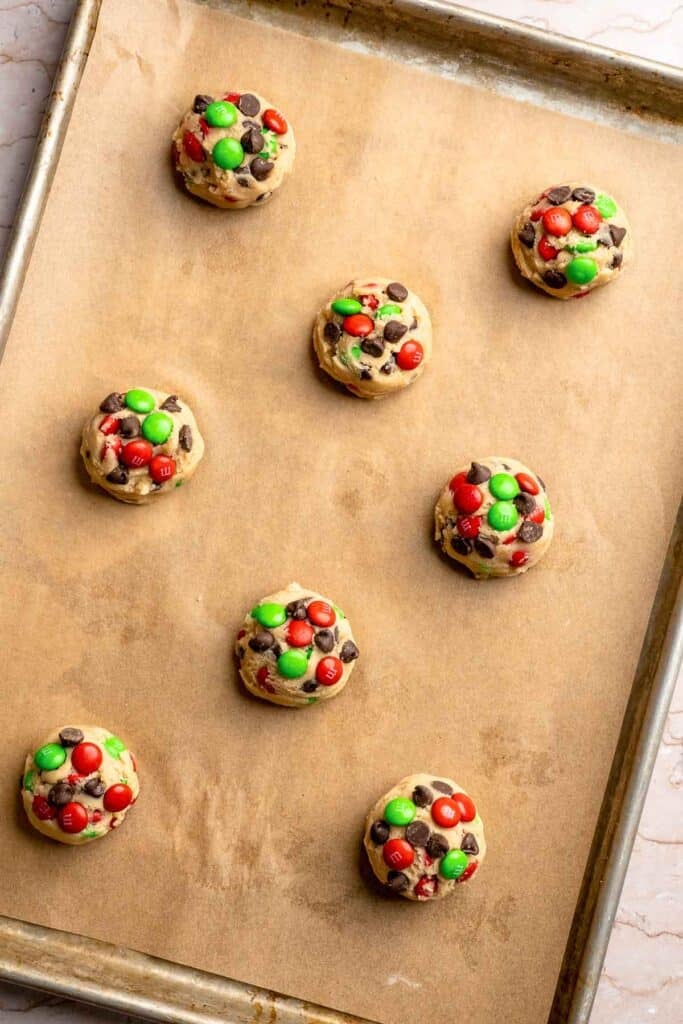 Festive red and green M&M Christmas Cookies that are soft, chewy, and crisp at the edges. Quick and easy, ready in about 20 minutes. | aheadofthyme.com