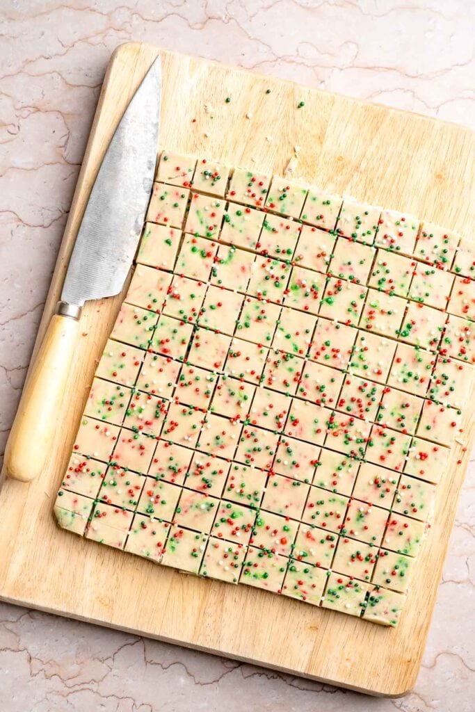 Funfetti Christmas shortbread cookie bites are squares of buttery melt in your mouth mini cookies packed with festive sprinkles for a fun holiday treat. | aheadofthyme.com