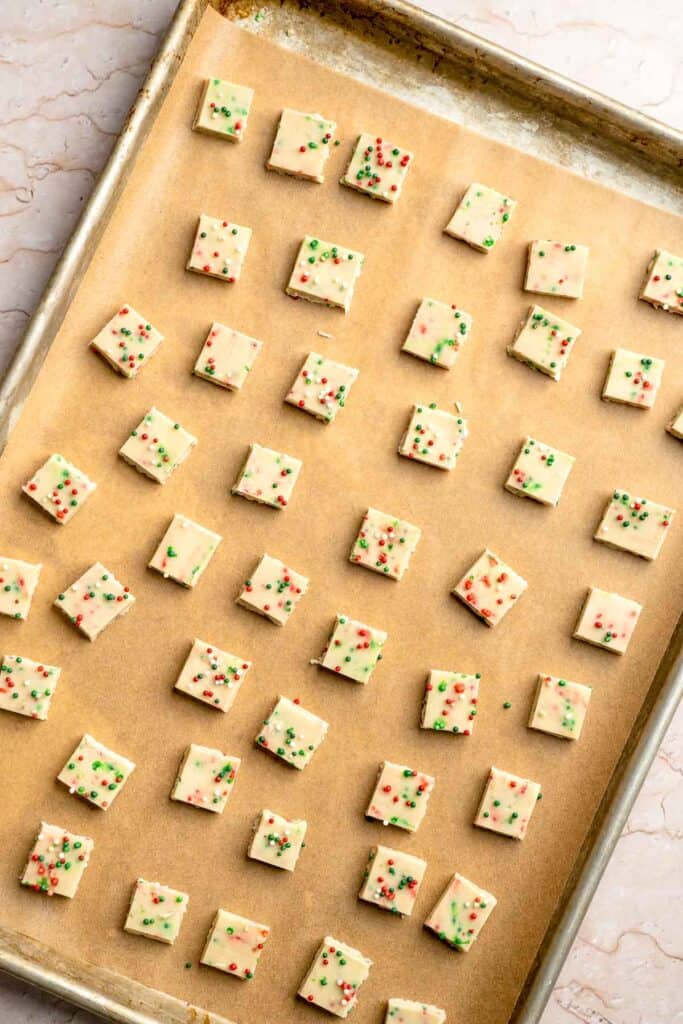Funfetti Christmas shortbread cookie bites are squares of buttery melt in your mouth mini cookies packed with festive sprinkles for a fun holiday treat. | aheadofthyme.com