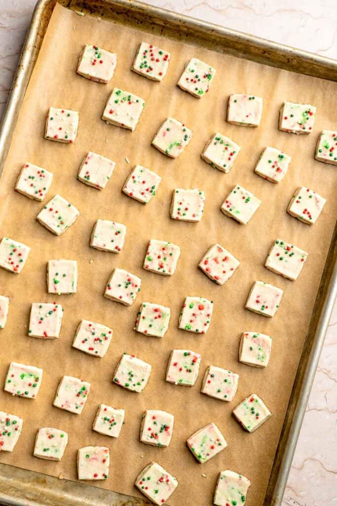 Funfetti Christmas shortbread cookie bites are squares of buttery melt in your mouth mini cookies packed with festive sprinkles for a fun holiday treat. | aheadofthyme.com