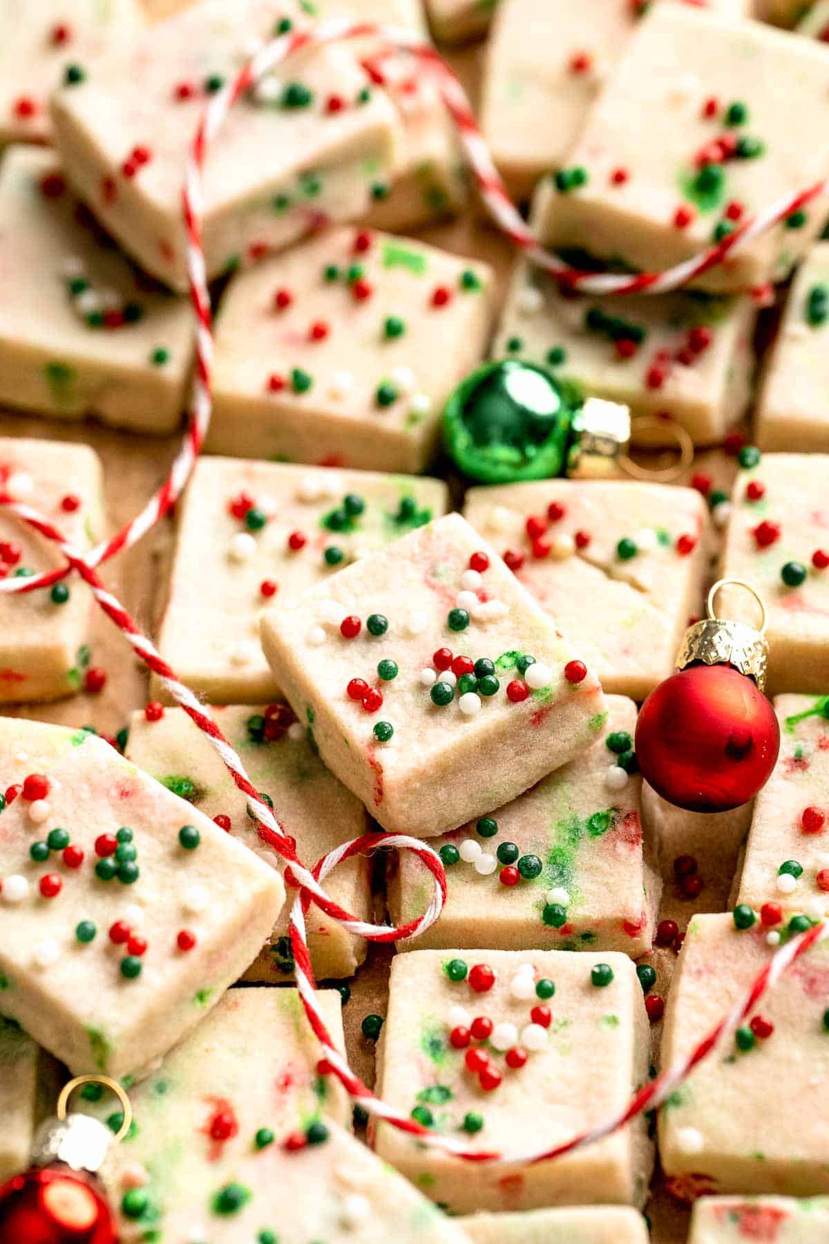 Funfetti Christmas shortbread cookie bites are squares of buttery melt in your mouth mini cookies packed with festive sprinkles for a fun holiday treat. | aheadofthyme.com