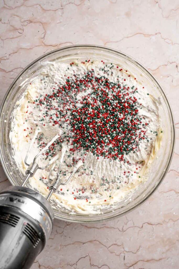 Funfetti Christmas shortbread cookie bites are squares of buttery melt in your mouth mini cookies packed with festive sprinkles for a fun holiday treat. | aheadofthyme.com