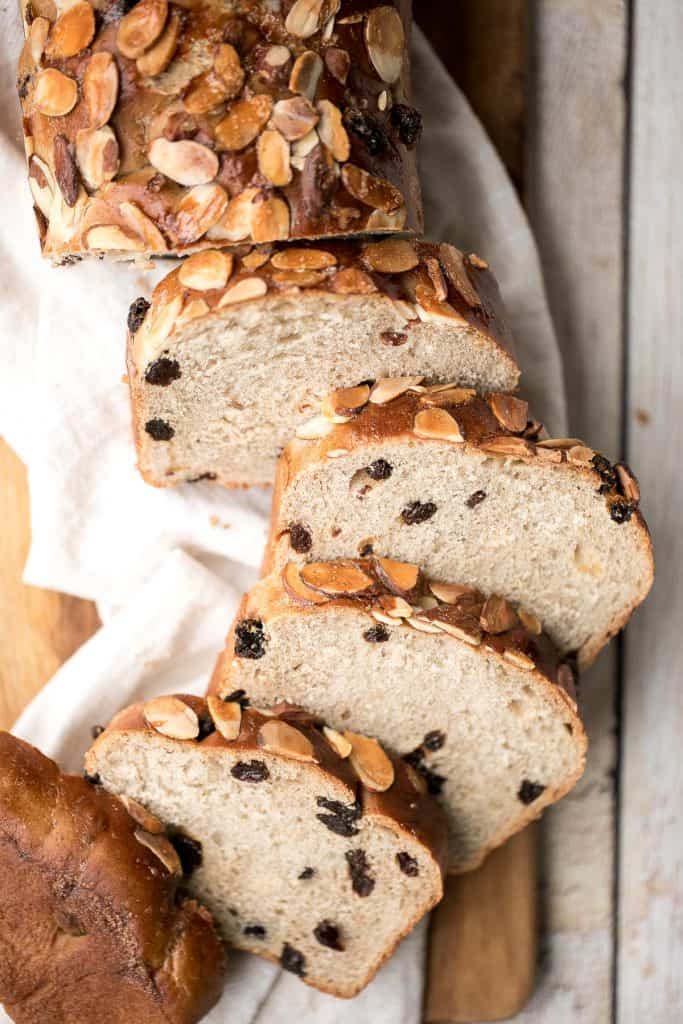 Sweet cinnamon raisin challah bread is airy, soft and fluffy with a beautiful golden crust coated with almonds. It is braided and baked in a loaf pan. | aheadofthyme.com