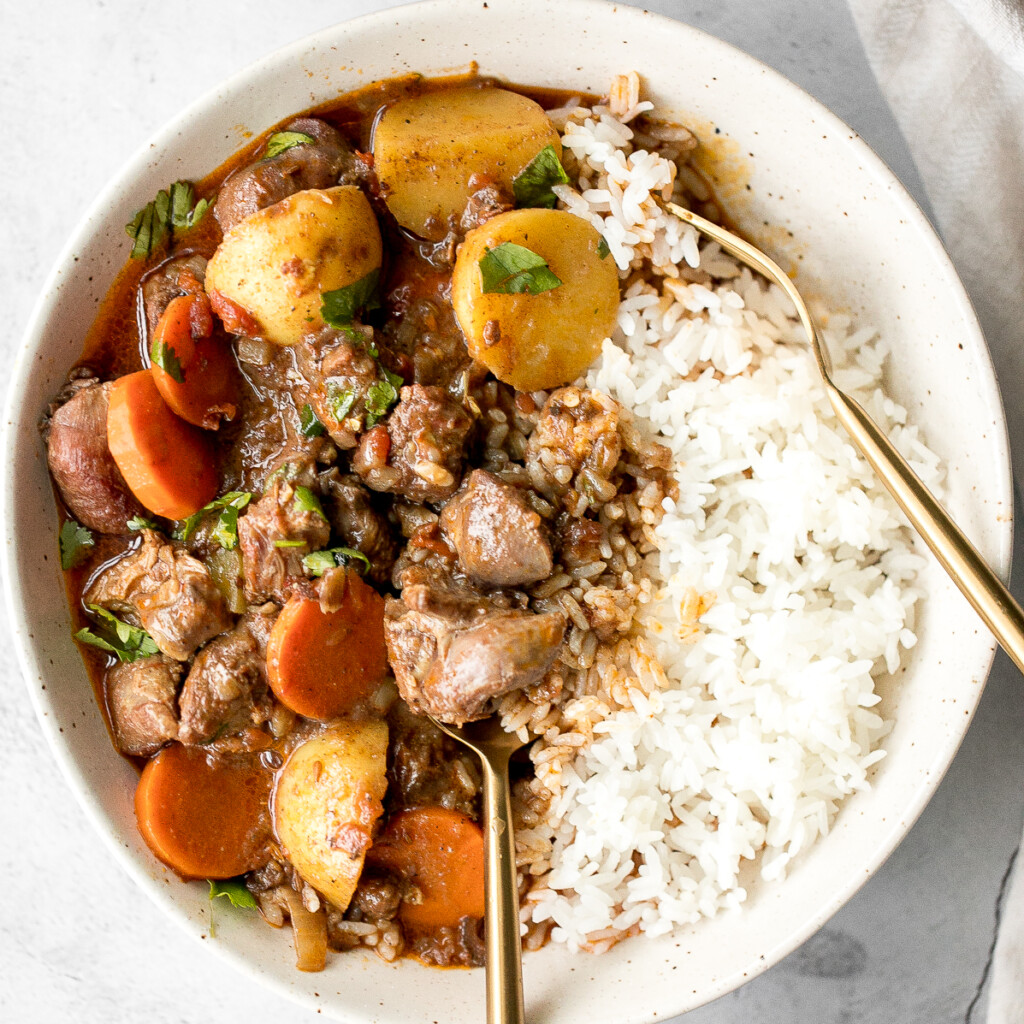 Hearty coconut lamb curry is an easy one pot meal that is packed with flavour. Make it on the stovetop or in the slow cooker and freeze leftovers for later. | aheadofthyme.com