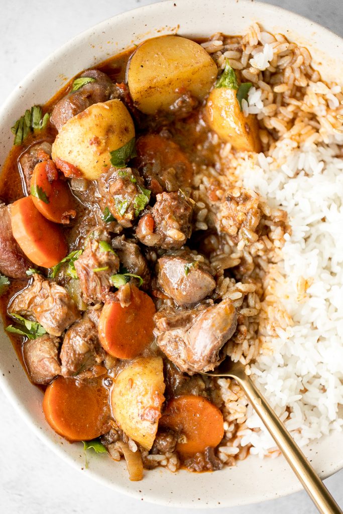 Hearty coconut lamb curry is an easy one pot meal that is packed with flavour. Make it on the stovetop or in the slow cooker and freeze leftovers for later. | aheadofthyme.com