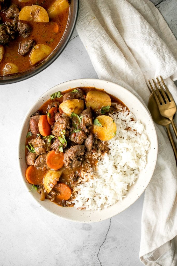 Hearty coconut lamb curry is an easy one pot meal that is packed with flavour. Make it on the stovetop or in the slow cooker and freeze leftovers for later. | aheadofthyme.com