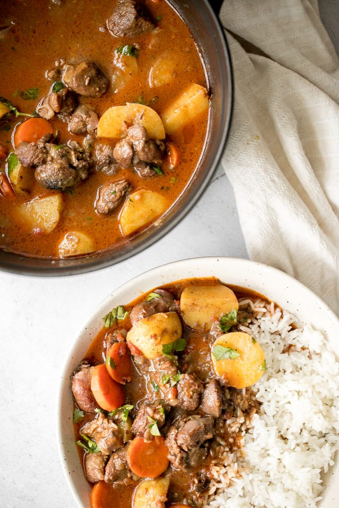 Hearty coconut lamb curry is an easy one pot meal that is packed with flavour. Make it on the stovetop or in the slow cooker and freeze leftovers for later. | aheadofthyme.com