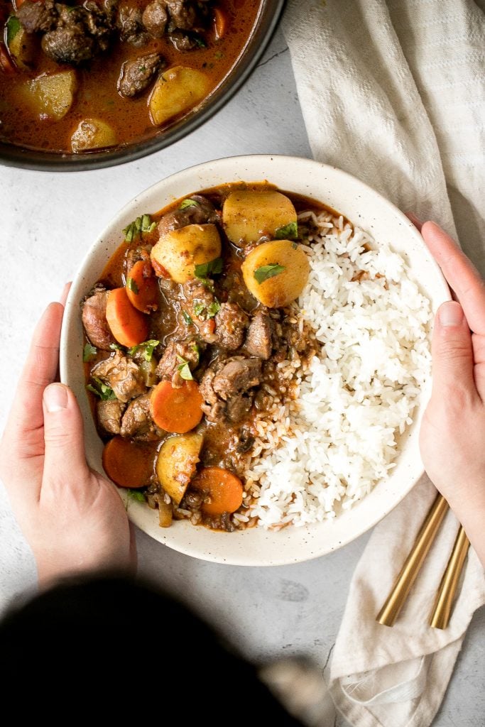 Hearty coconut lamb curry is an easy one pot meal that is packed with flavour. Make it on the stovetop or in the slow cooker and freeze leftovers for later. | aheadofthyme.com