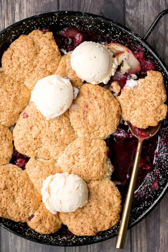 Sweet and tart cranberry-apple cobbler with biscuits is packed with fresh fruit and a buttery biscuit topping. This holiday favourite is easy to make. | aheadofthyme.com