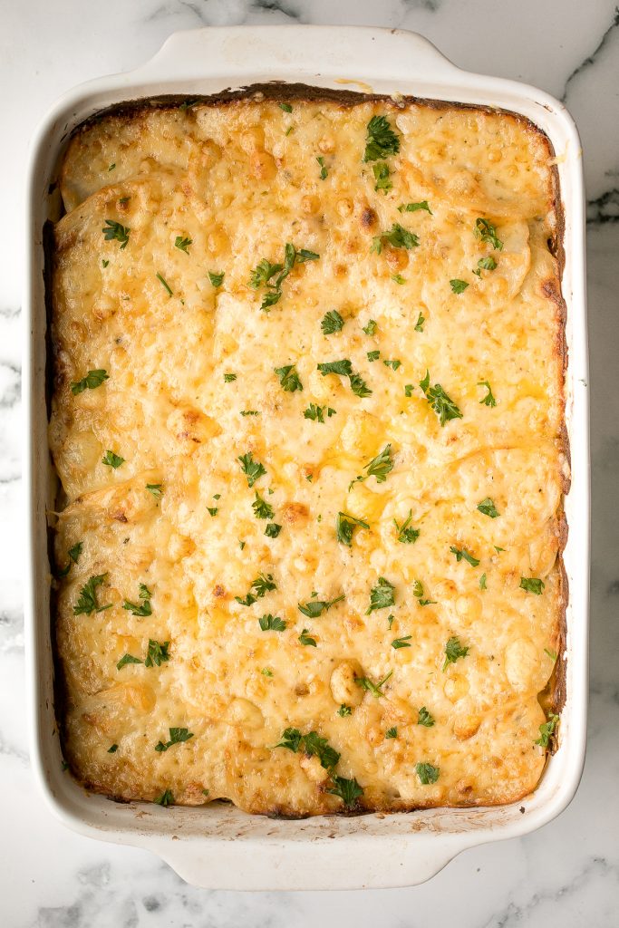 Easy creamy ham and potatoes au gratin is a great way to use leftover ham with tender sliced potatoes and a cheesy béchamel sauce. The best comfort food. | aheadofthyme.com
