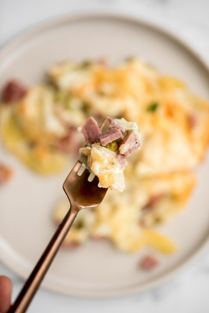 Easy creamy ham and potatoes au gratin is a great way to use leftover ham with tender sliced potatoes and a cheesy béchamel sauce. The best comfort food. | aheadofthyme.com