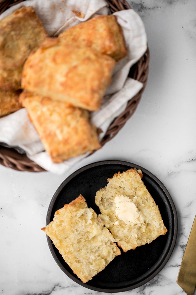 Flaky cornmeal cheddar biscuits are simple, buttery, cheesy, and so delicious. These savoury biscuits with perfect golden tops are quick and easy to make. | aheadofthyme.com