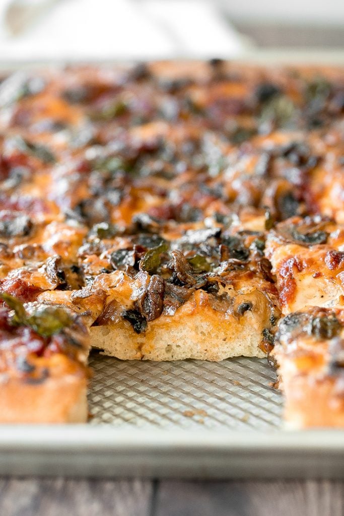 Sheet pan garlic mushroom focaccia pizza with a thick pillowy and crispy crust is topped with sautéed garlic mushrooms, melty mozzarella and lots of basil. | aheadofthyme.com