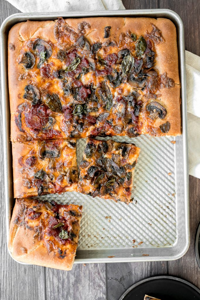 Sheet pan garlic mushroom focaccia pizza with a thick pillowy and crispy crust is topped with sautéed garlic mushrooms, melty mozzarella and lots of basil. | aheadofthyme.com
